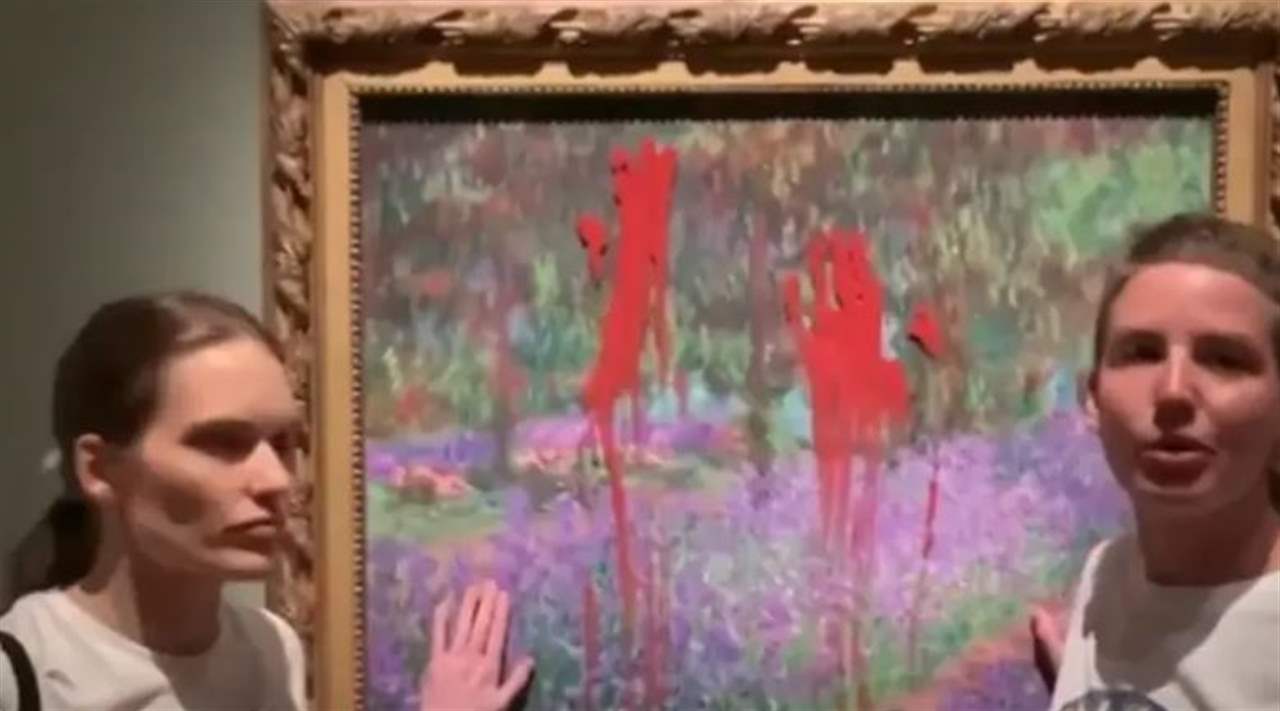 ناشطتا مناخ تلطخان لوحة لمونيه بالطلاء الأحمر